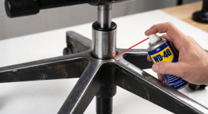Applying WD-40 to the office chair base and gas lift connection joint